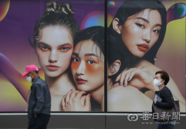 정부가 실외 마스크 착용 해제에 대한 논의에 들어가면서 갑론을박이 벌어지고 있는가운데 대구 시내 한 쇼핑몰 외벽 광고판 앞으로 마스크를 쓴 시민이 지나가고있다. 우태욱 기자 woo@imaeil.com