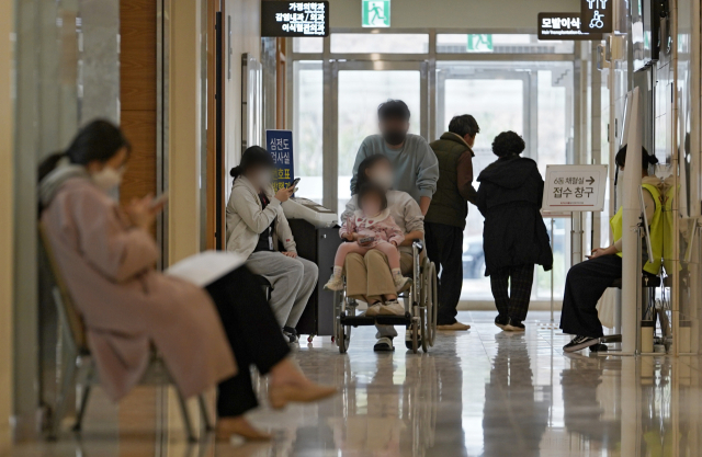 대구 한 상급종합병원에서 휠체어에 앉은 환자가 보호자의 도움을 받아 이동하고 있다. 김영진 기자 kyjmaeil@imaeil.com